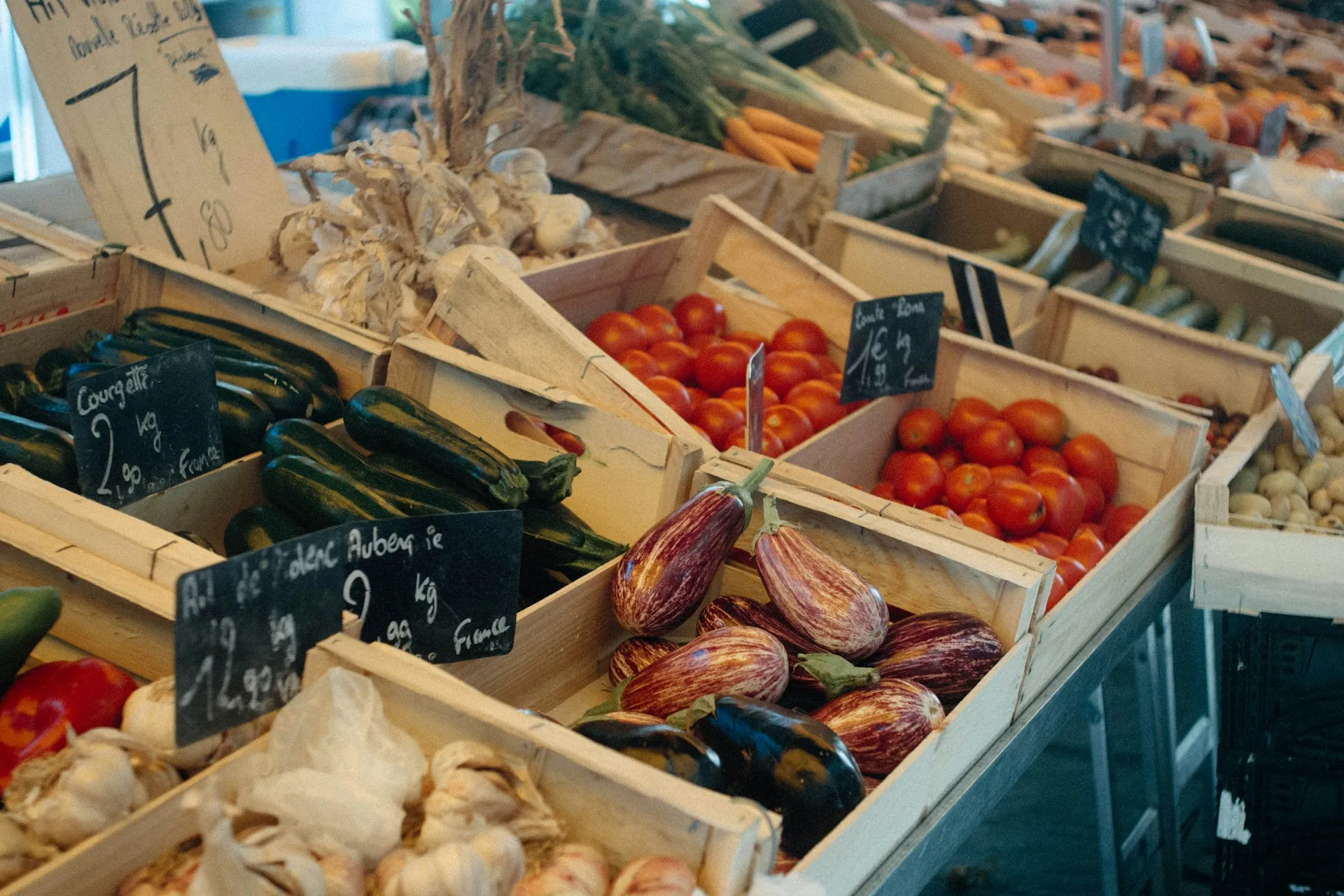 Crates of produce set out on a market stall.