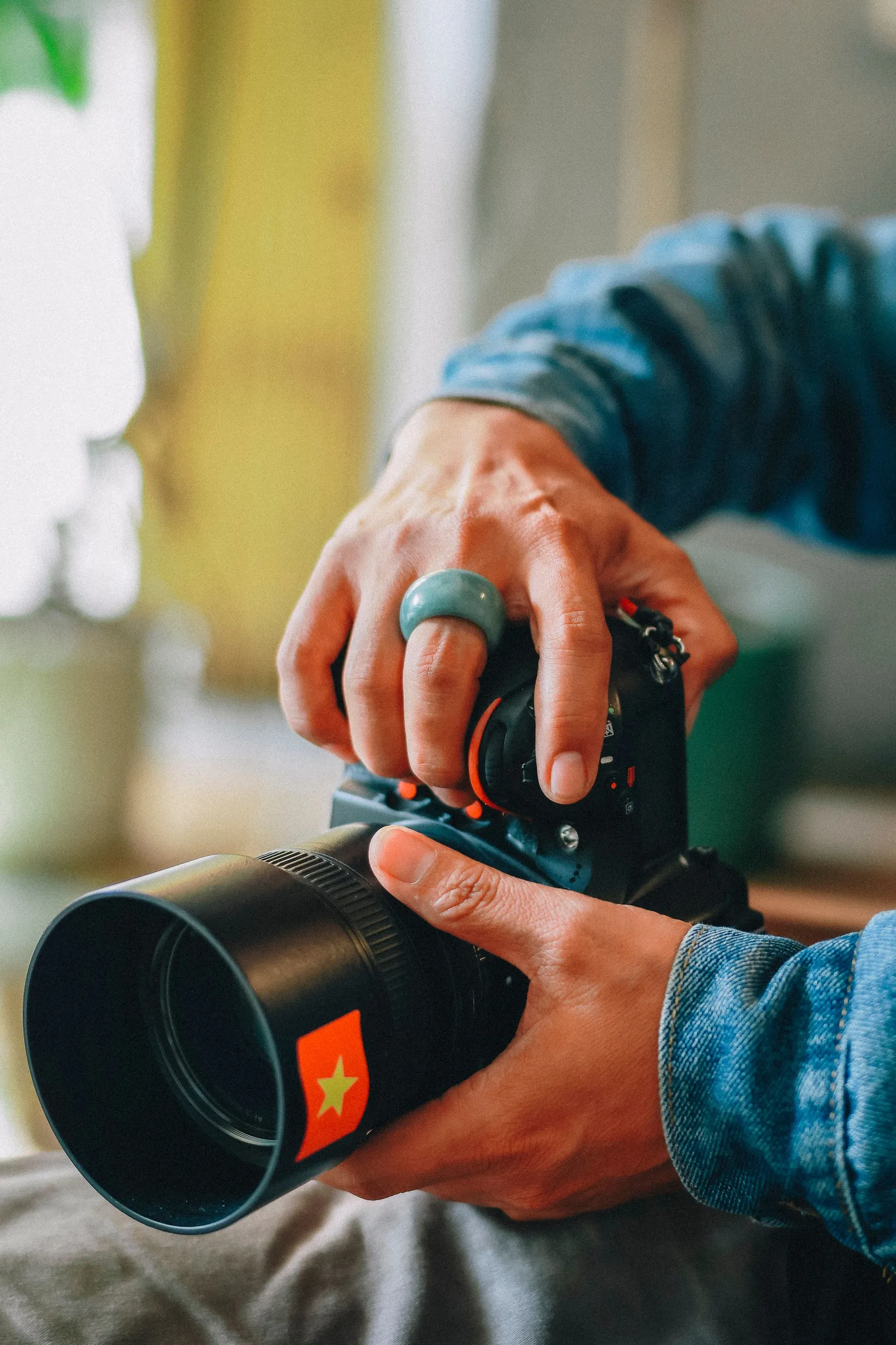 A camera operator lining up a shot on a handheld rig.