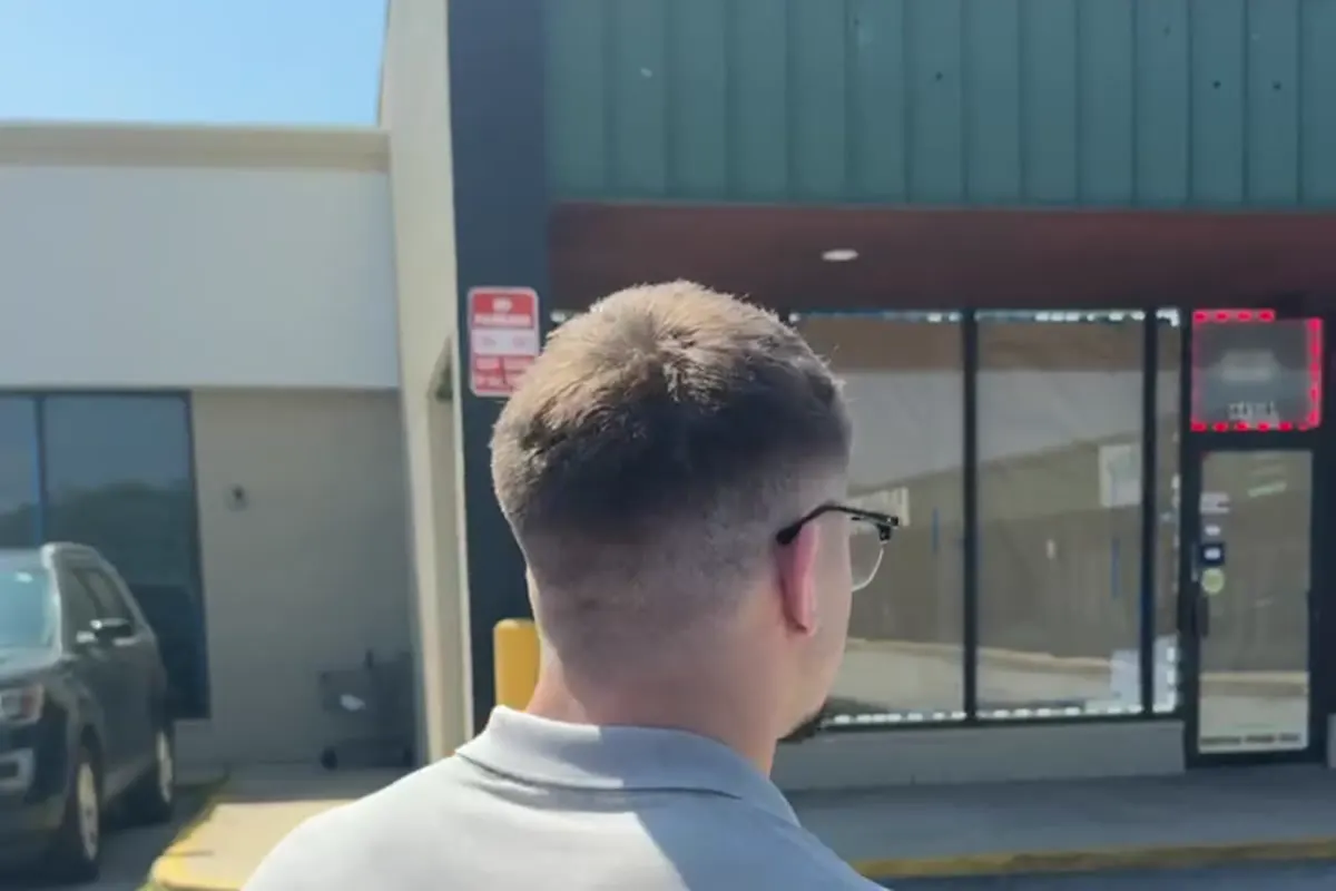 Walking up to a storefront on a strip mall.